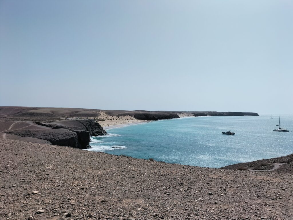 Route to reach Papagayo beach. In the background the sea and two boats.