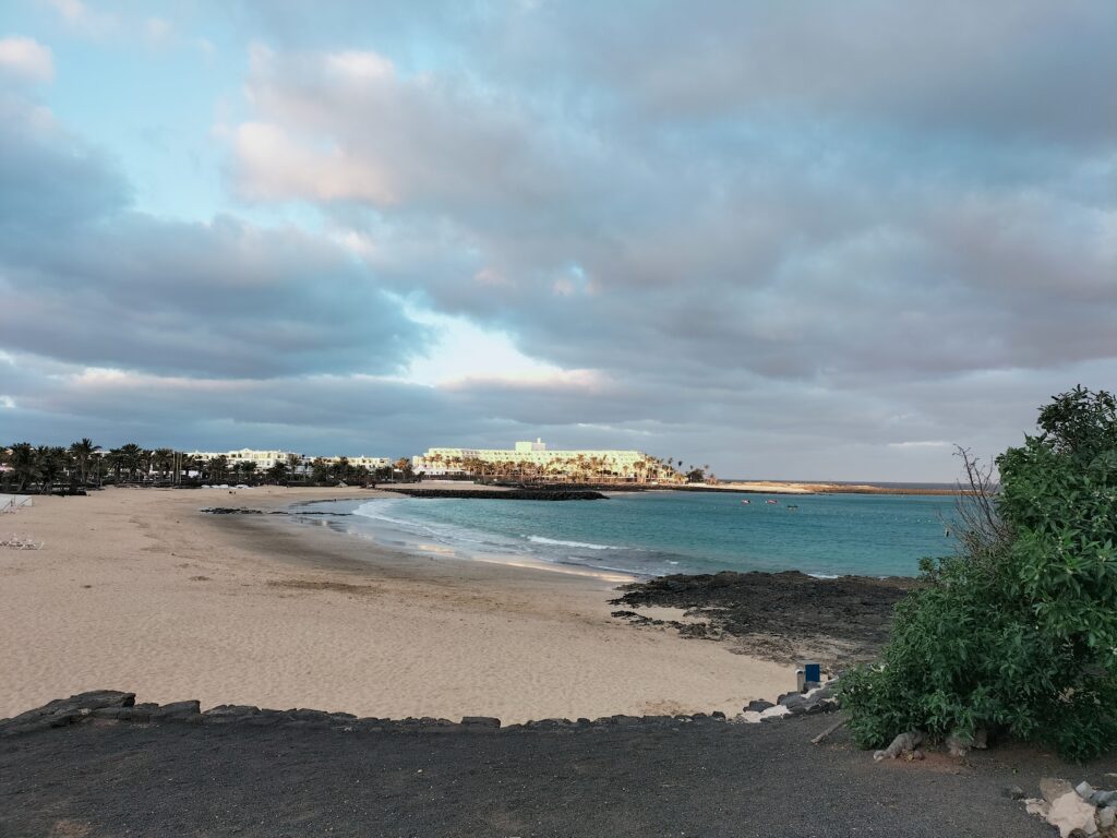 Photo of Costa Teguise with the main beach and the white town in the background.