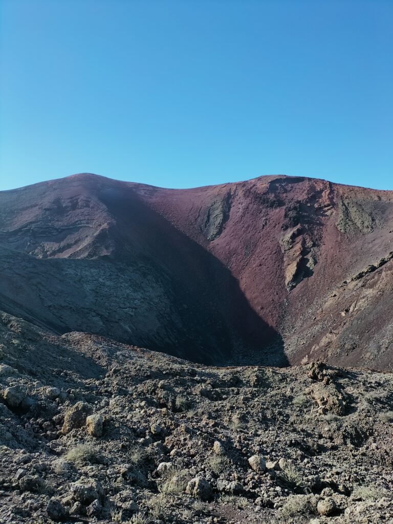 The interior of the volcano. In the background the blue sky.