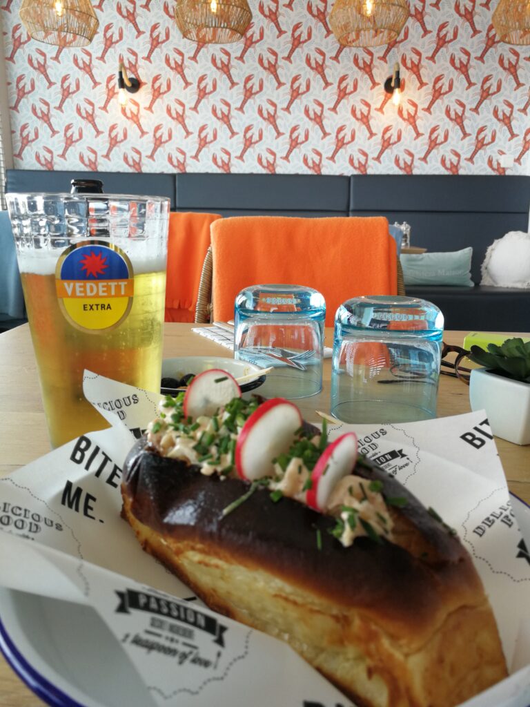 Interior of Lobster 'n rolls with my lobster sandwich and a Vedett beer.