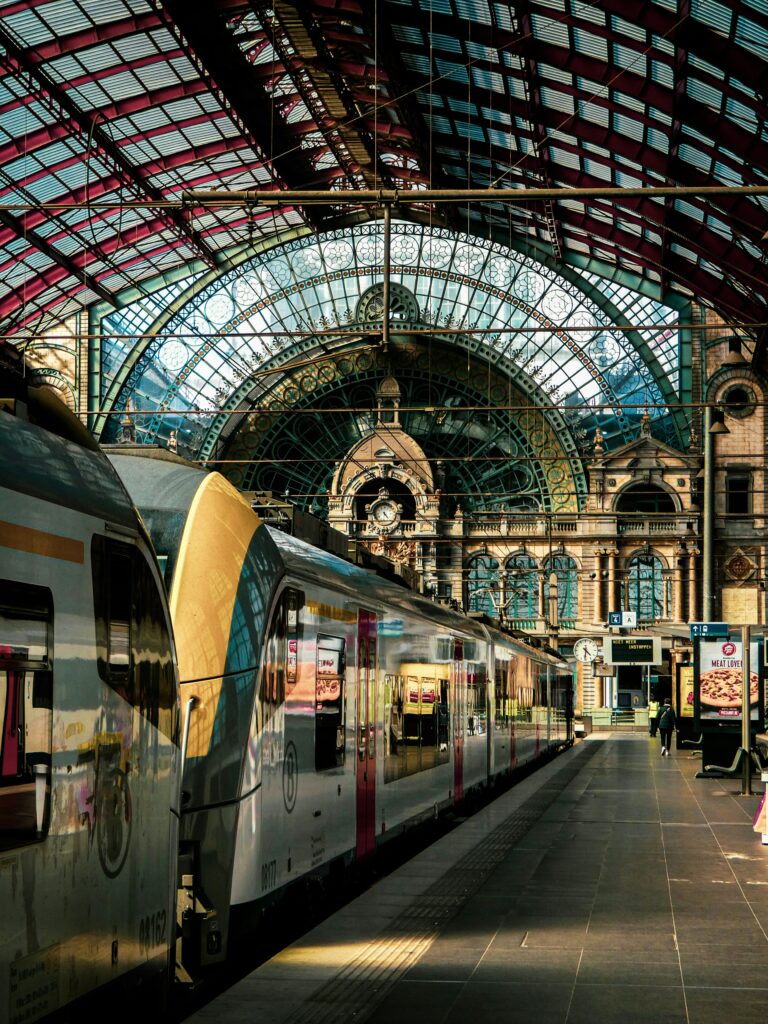 Picture of the Central Station of Antwerp. In the foreground there is a train.