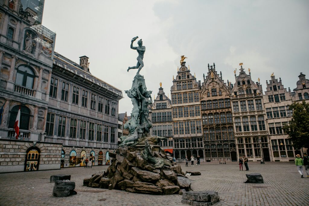 The statue of Brabo in the middle of Grote Markt. In the background the facades of the medieval buildings.