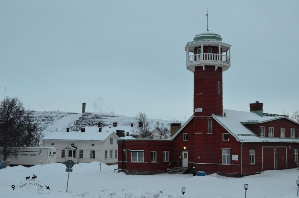 Typical Swedish red building that stands out in a totally snow-covered context in the center of Kiruna.