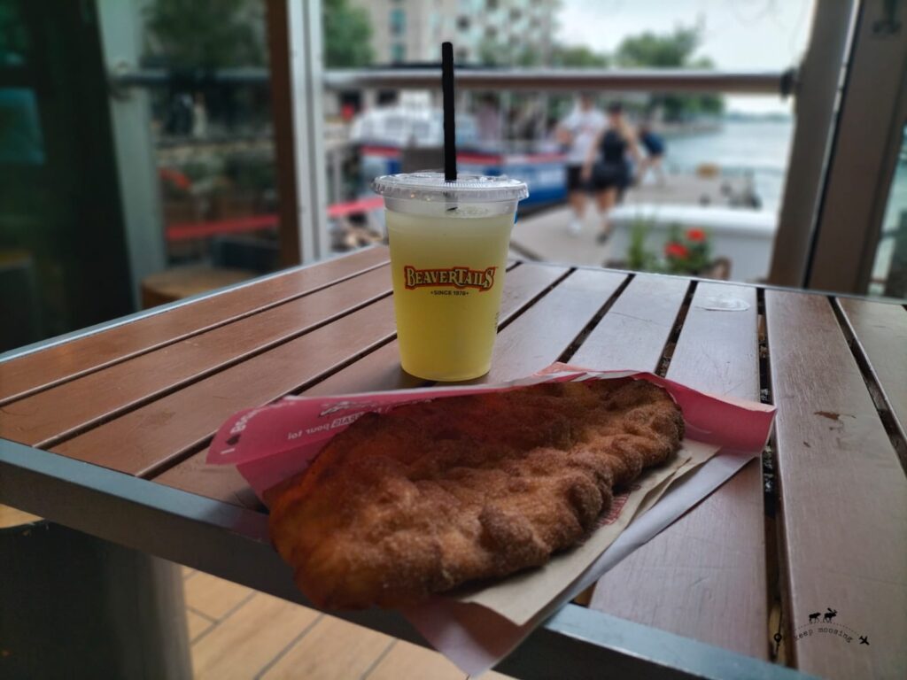 The lemonade and the beaver tail on the table.