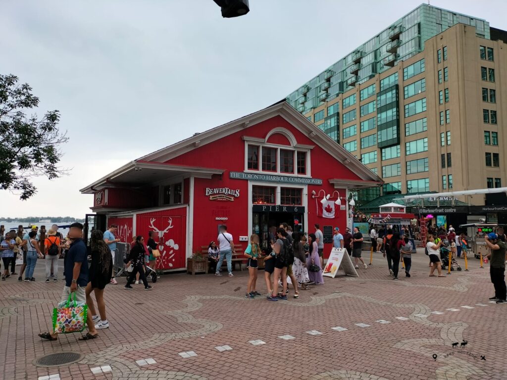 The red house of Beaver Tails. A lot of people are walking on the street