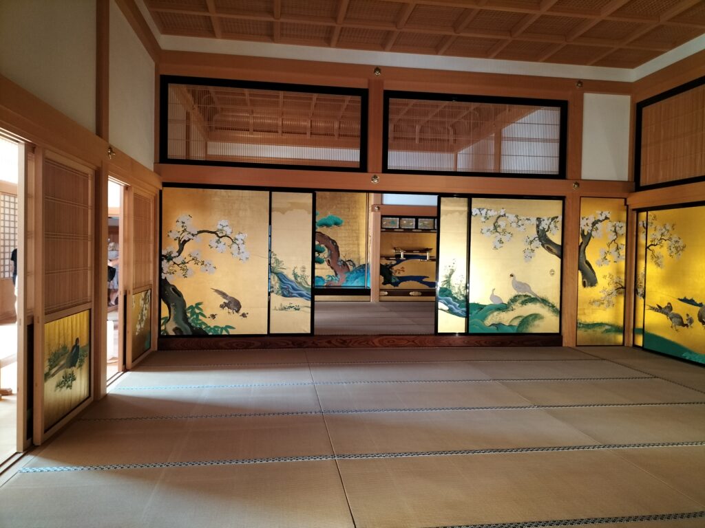 The interiors of Nagoya Castle with walls with golden decorations.