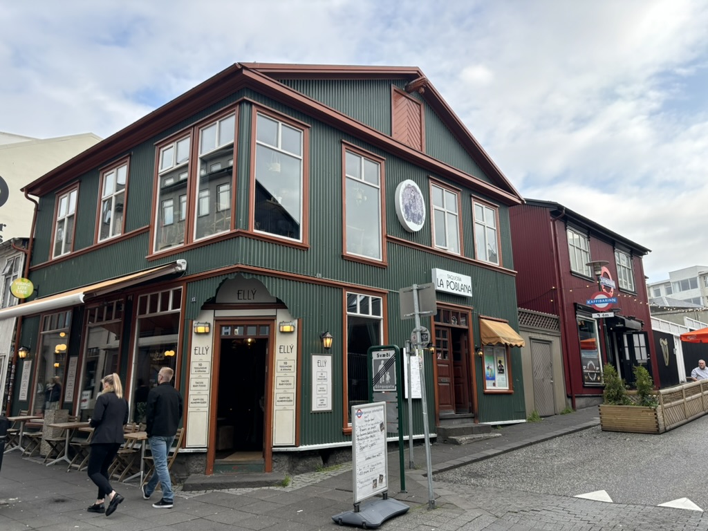 Green wooden house in the city.