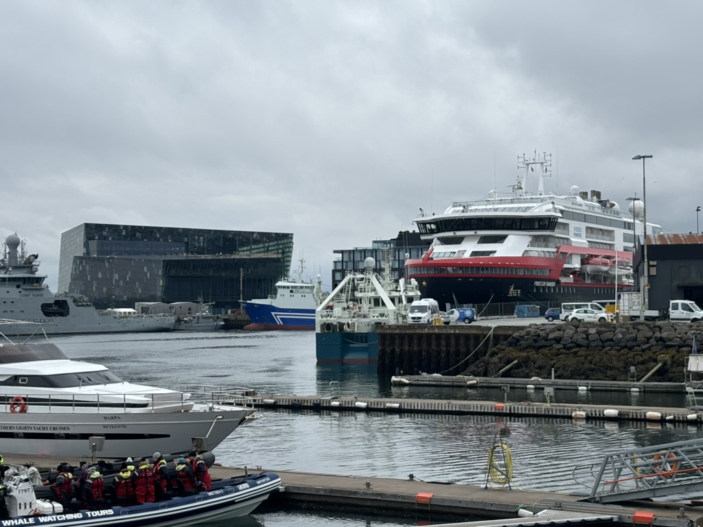 Harbour of Reykjavik with Harpa in the background and various boats.