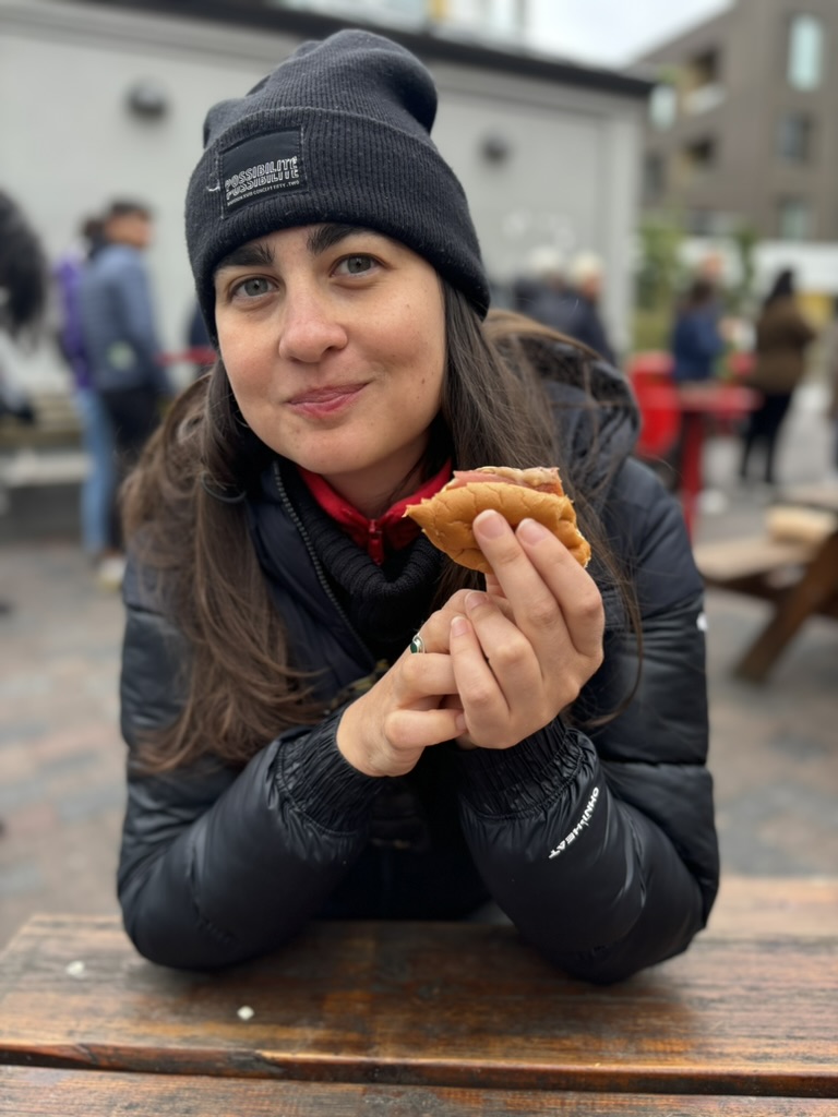 Claudia eating the hotdog.