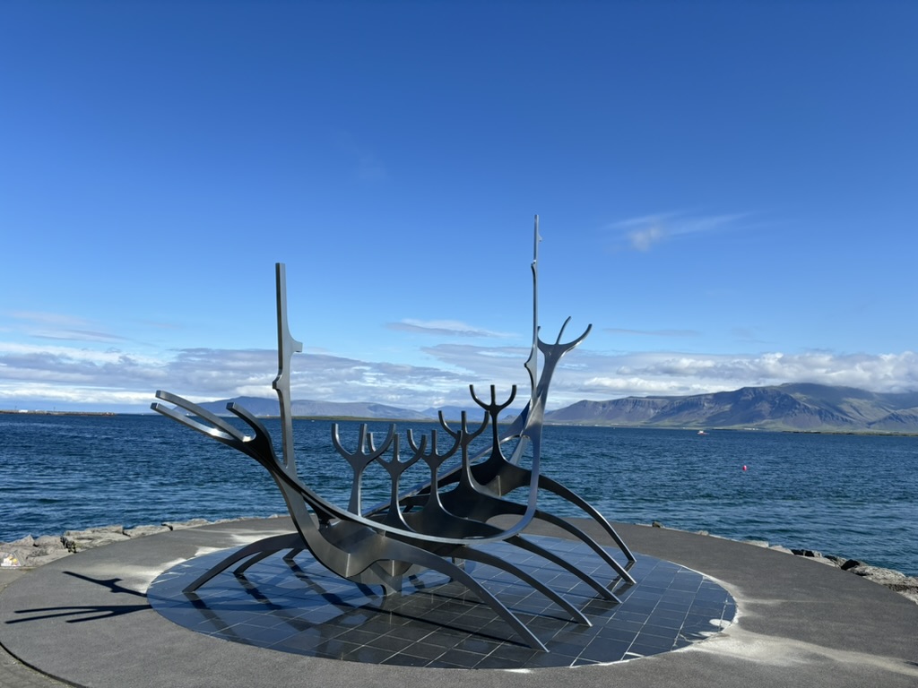 Sun Voyager Sculpture with mountains in the background.