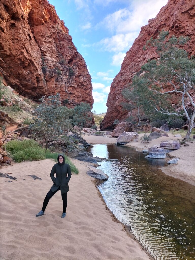 Claudia at Simpons's Gap with trees and mountain behind.