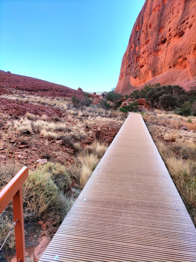 Path back to the Olgas with red sand and blue sky.