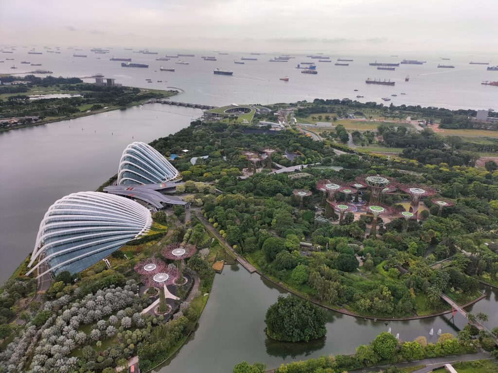 View from above the SkyDeck, looking at the glass domes and the ships in the Singapore bay.