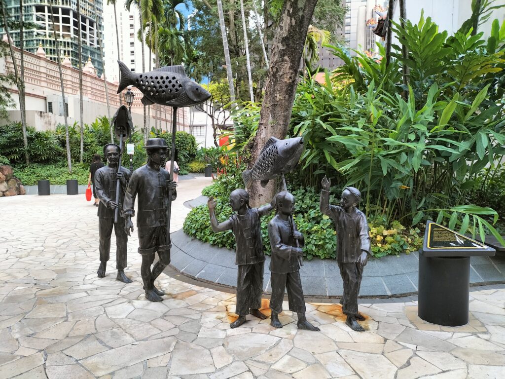 Installation in China Town representing people with fish.