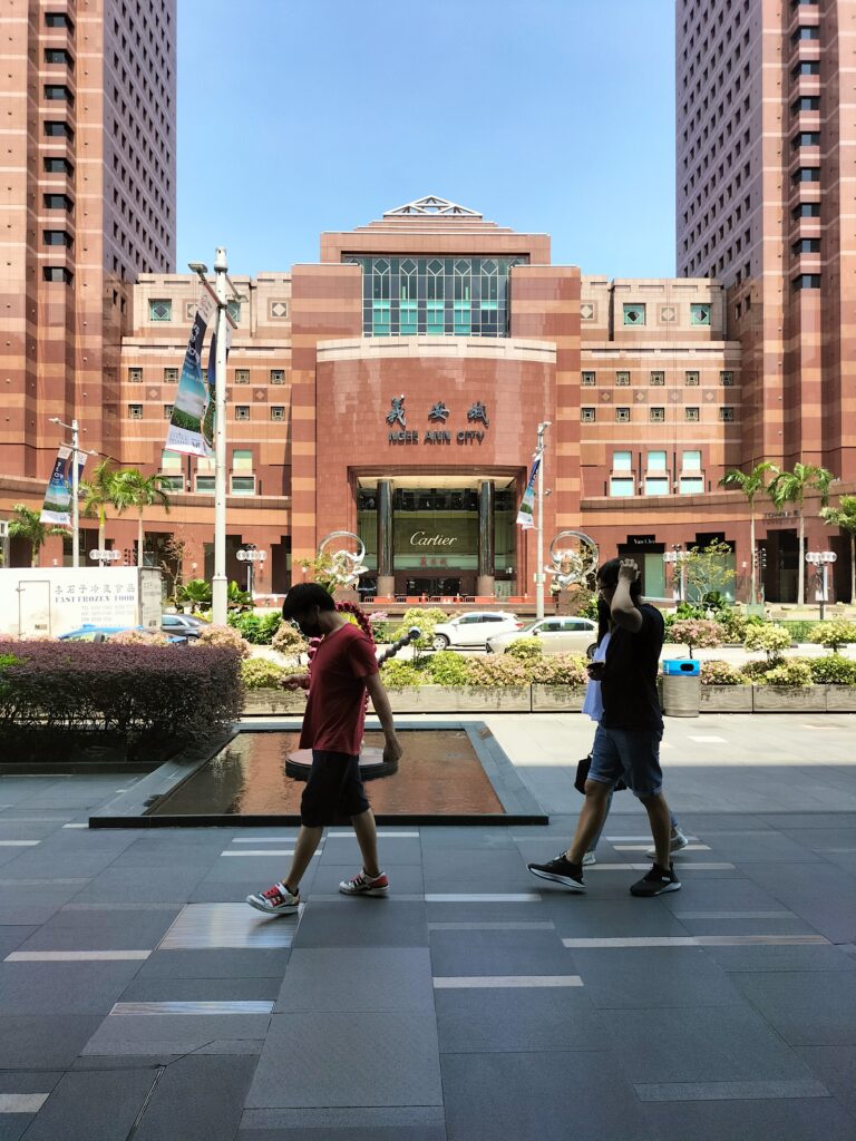 Orchard Road in Singapore. 3 men on the street.