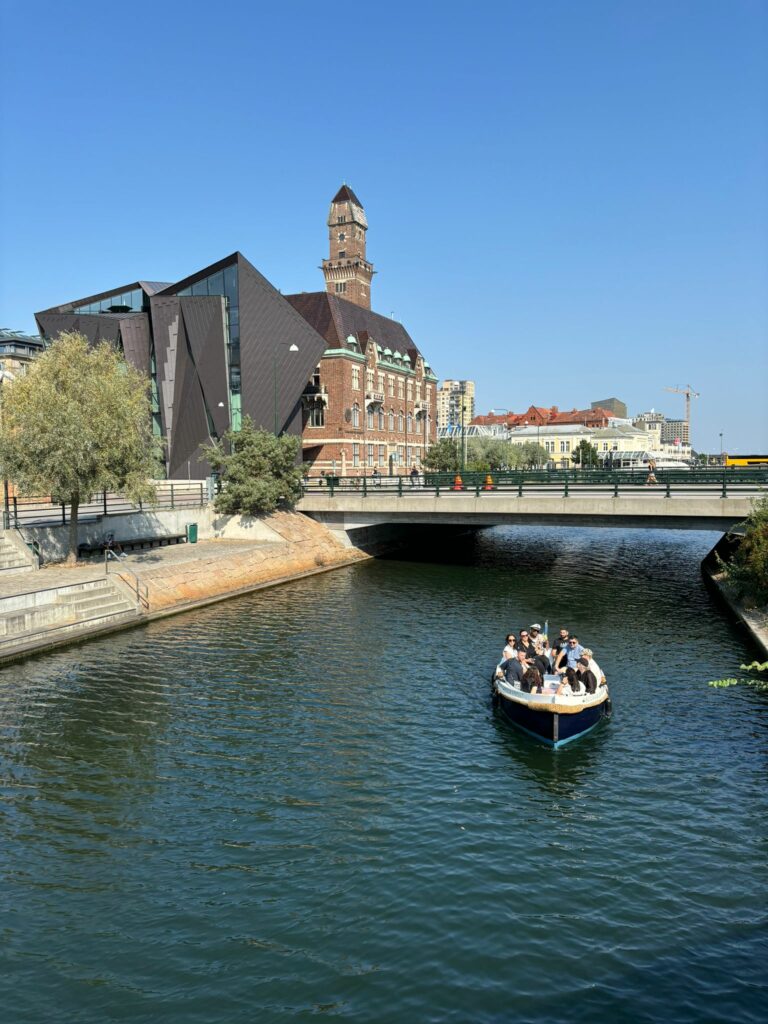 River passing through Malmo with a boat.