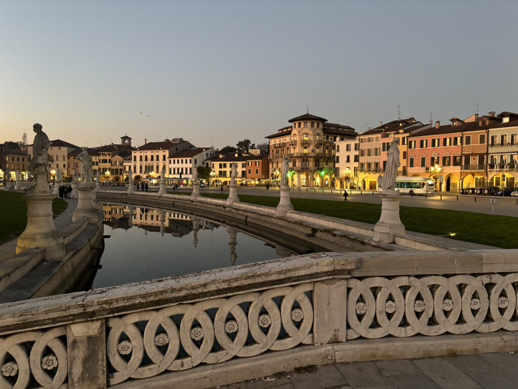 Prato della Valle with a bridge and houses behind.