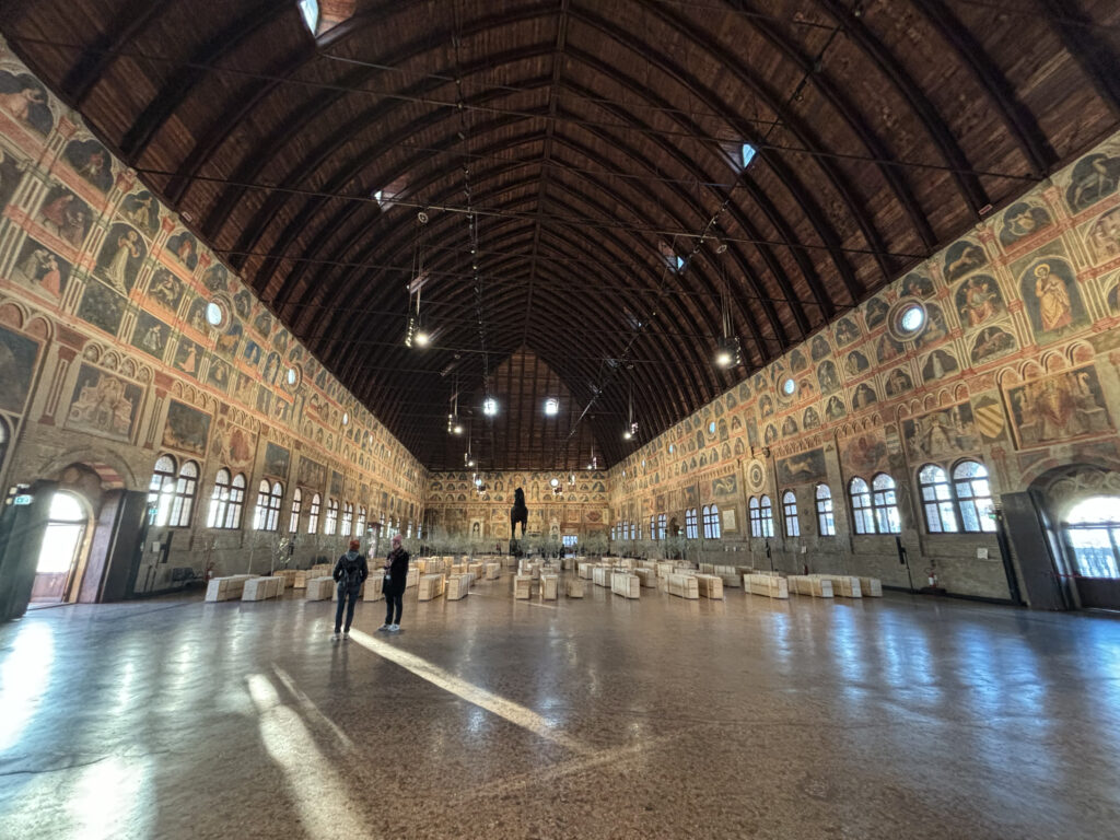 View of the inside of Palazzo della Ragione with Giotto's frescoes and Yoko Ono installation.