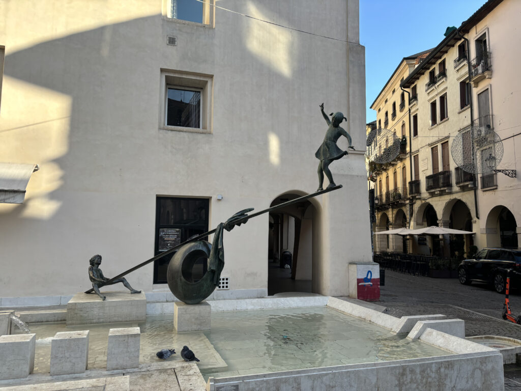 A statue representing two kids playing in city centre.