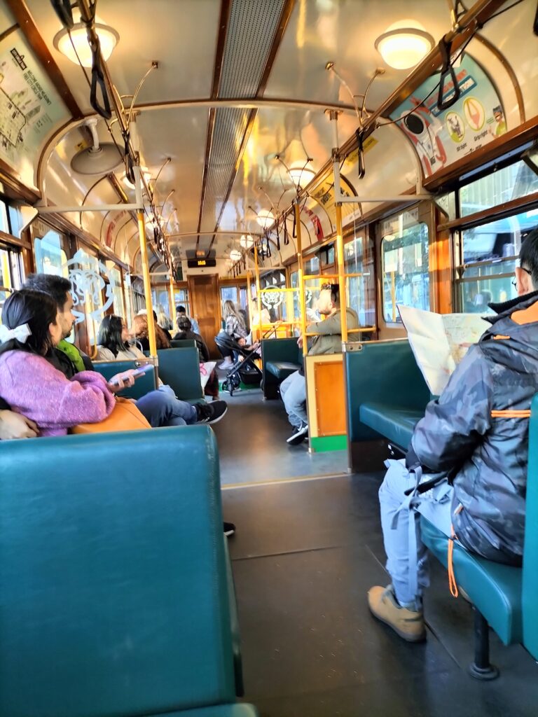 City Circle Tram 35 from the inside with some people sit.