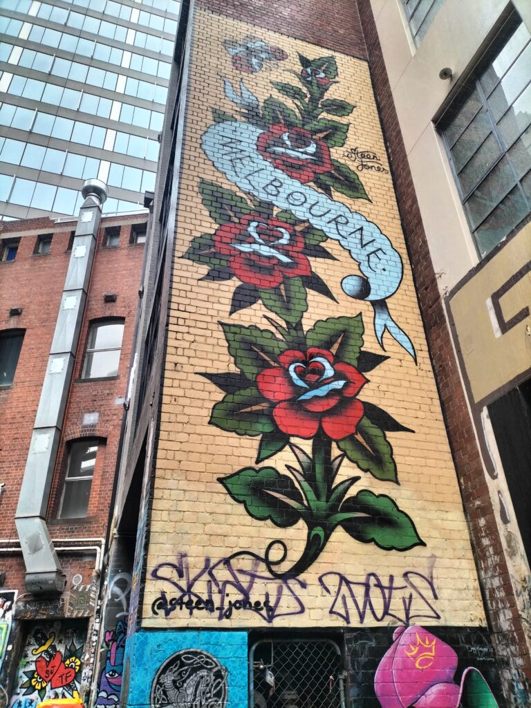 Murales in Melbourne with roses depicted on a wall.