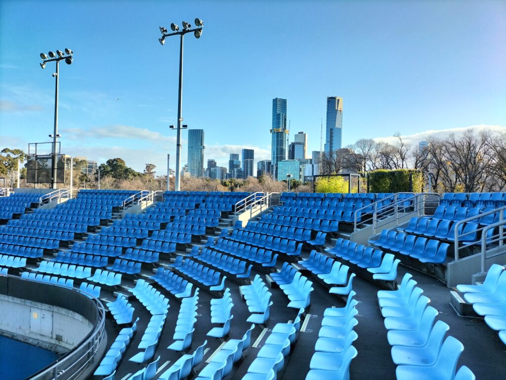 Tennis court with skyscrapers in the background.