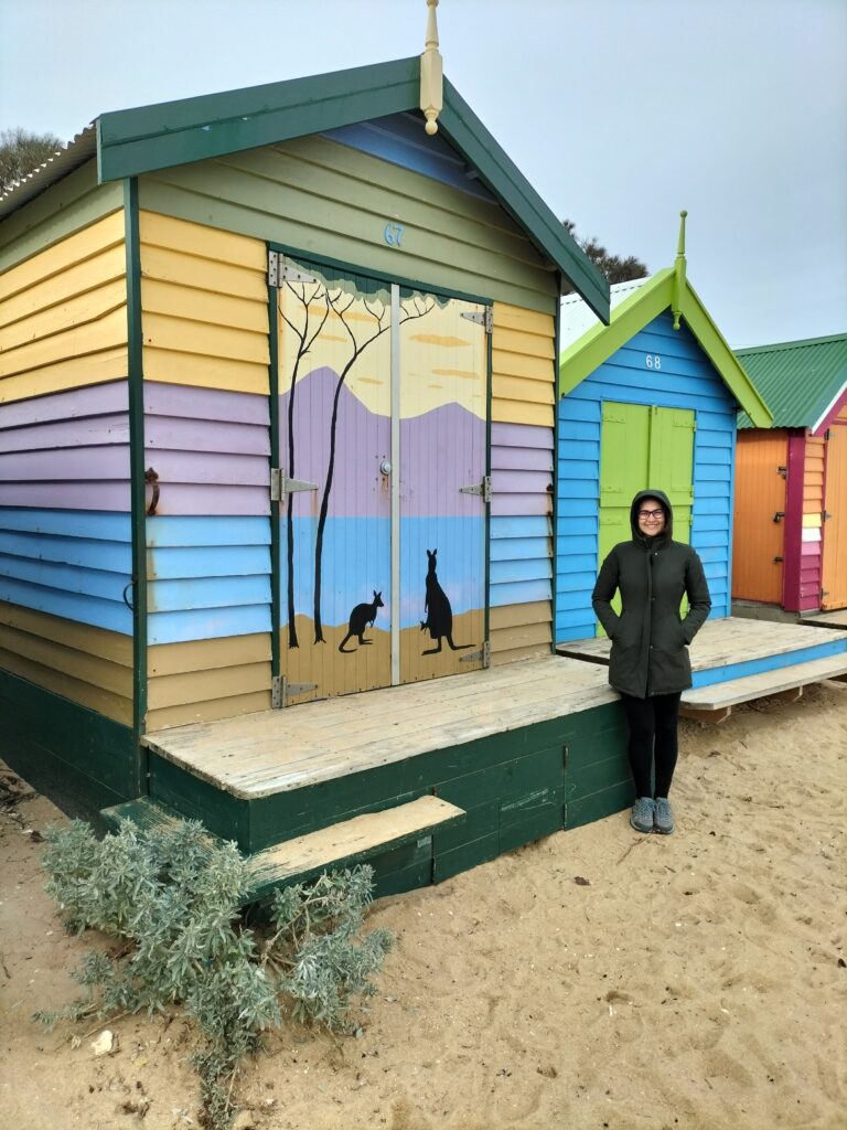 Claudia in front of a hut.