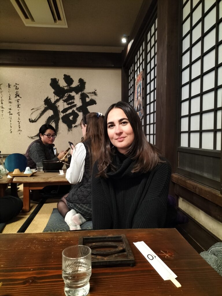 Claudia si at Hoto Fudo with people sit behind. What To Do in Lake Kawaguchi in 2 Days